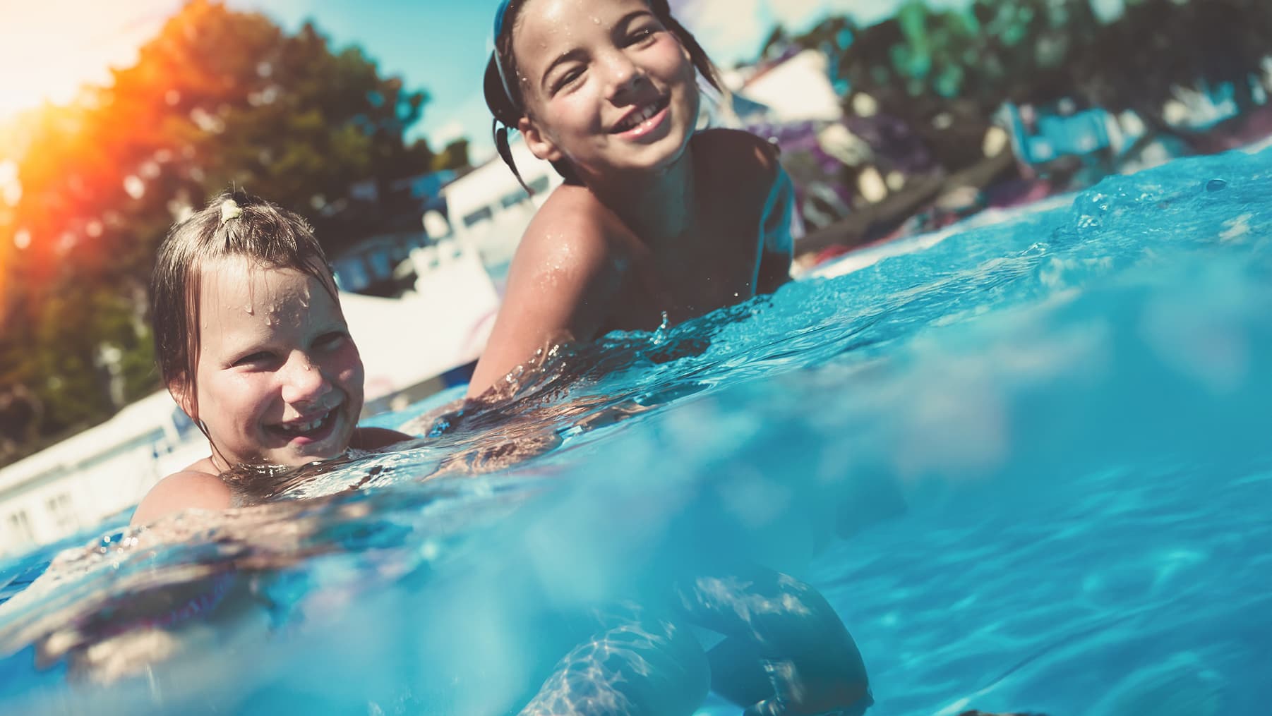 Beautiful swimming pool with clear blue water showcasing pool heating services