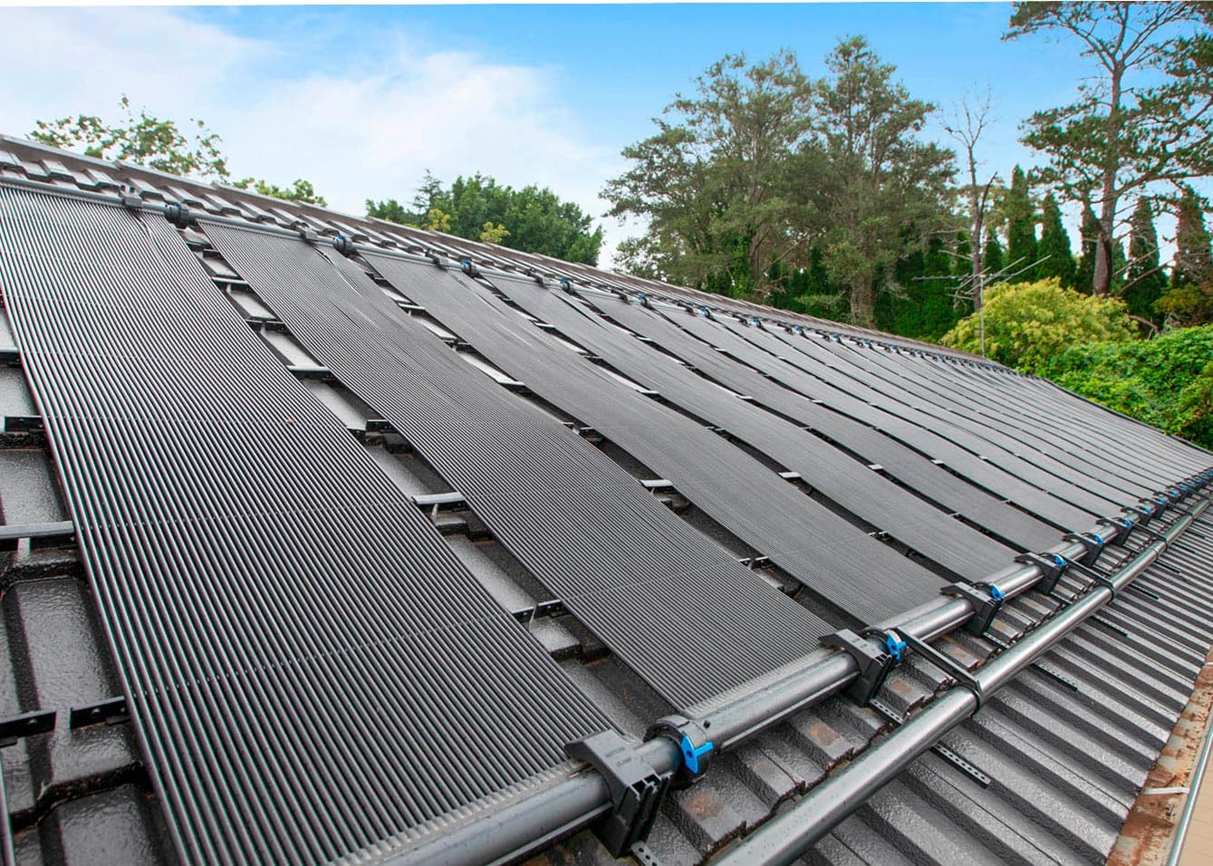 Solar panels installation on roof demonstrating pool heating technology